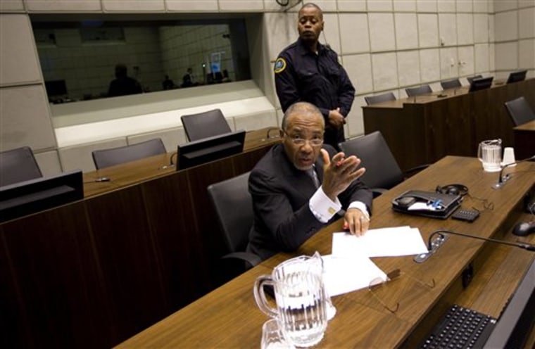 Former Liberian President Charles Taylor argues with a photographer as he awaits the start of the prosecution's closing arguments during his trial at the U.N.-backed Special Court for Sierra Leone in Leidschendam on Feb. 8. Taylor's lawyer stormed out of court Tuesday after judges refused to accept a written summary of the former Liberian president's defense case at the end of his war crimes trial. 